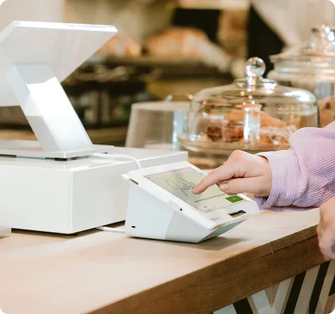 Clover Station Duo on a countertop, customer tapping to pay