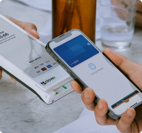 Clover Flex handheld, customer tapping card to pay